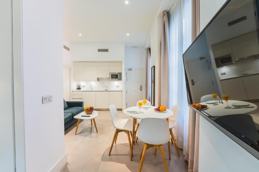 Open living room, dining table and kitchenette