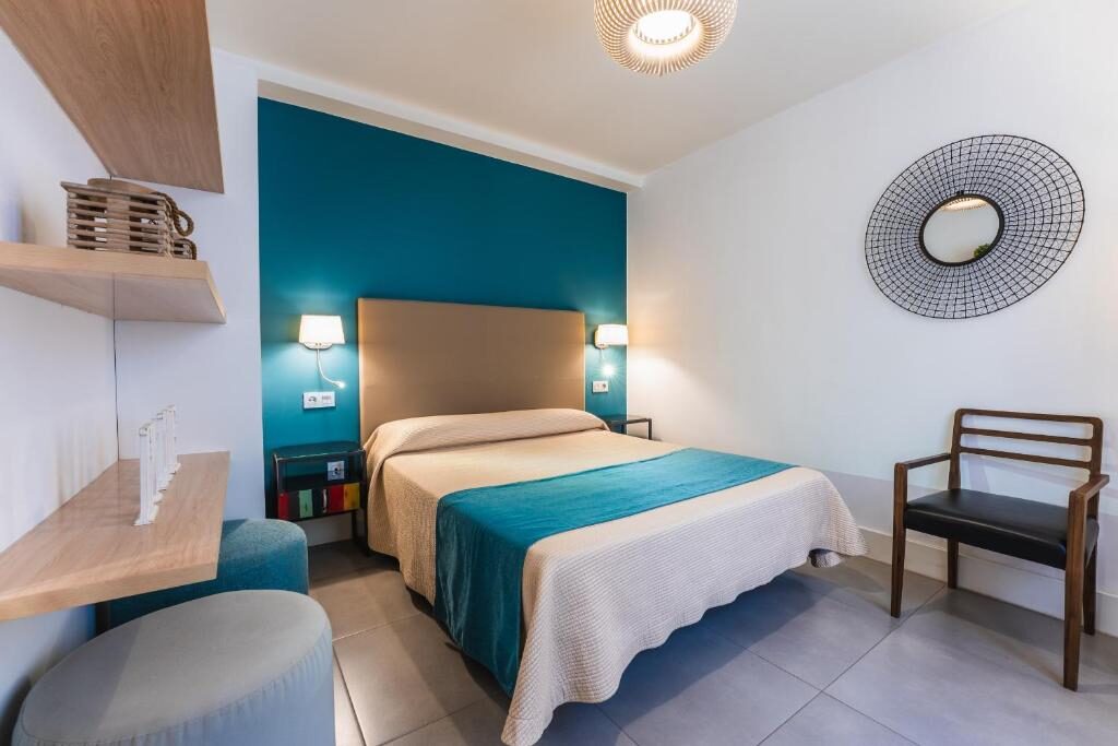 Bedroom with blue feature wall and desk